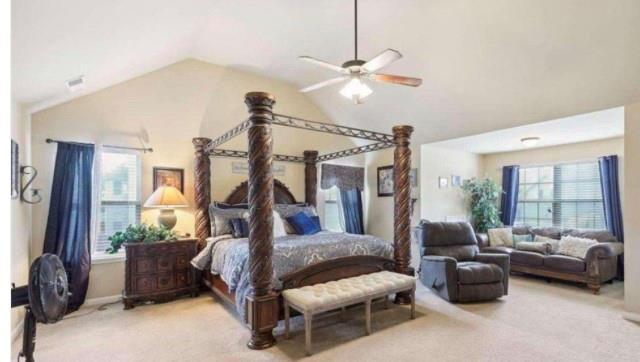 bedroom with lofted ceiling, carpet flooring, and ceiling fan