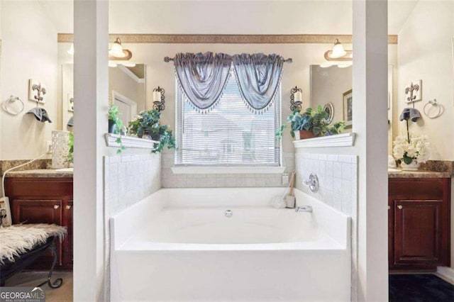 bathroom featuring a washtub and vanity