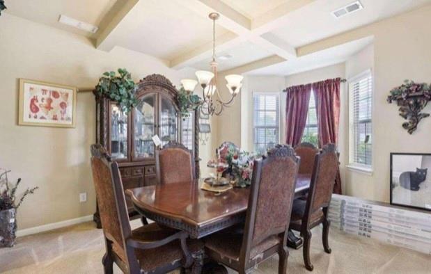 carpeted home office featuring vaulted ceiling