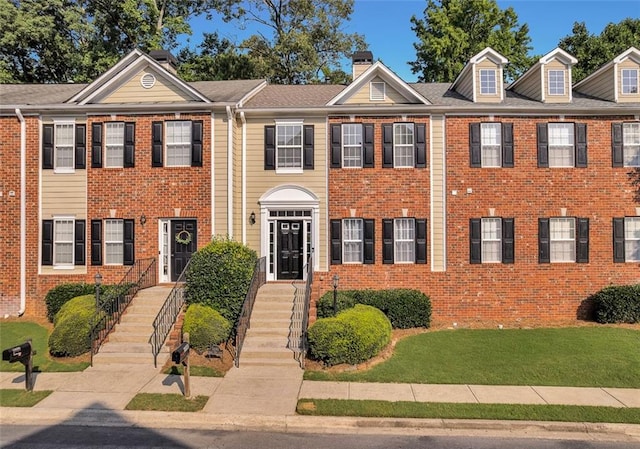 5990 Eagle Tiff Ln, Sugar Hill, GA 30518 - townhome / multi-family property with a chimney, brick siding, and a front yard