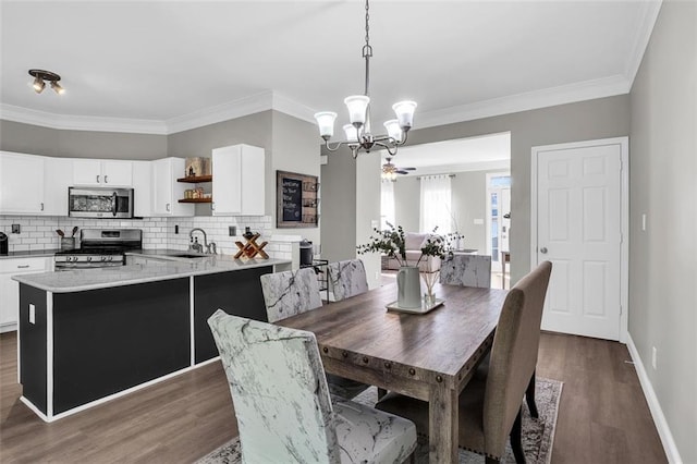 5990 Eagle Tiff Ln, Sugar Hill, GA 30518 - dining area featuring a chandelier, dark wood-type flooring, and ornamental molding