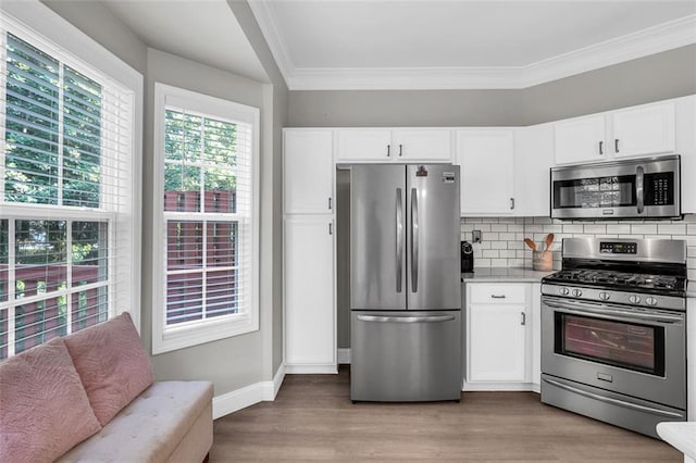5990 Eagle Tiff Ln, Sugar Hill, GA 30518 - kitchen featuring appliances with stainless steel finishes, light wood-type flooring, ornamental molding, backsplash, and white cabinetry