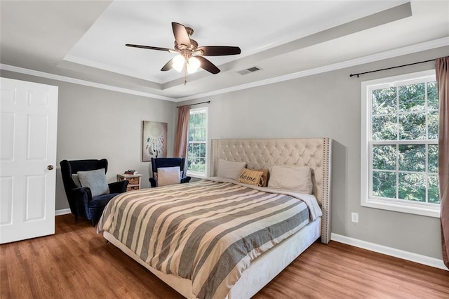 5990 Eagle Tiff Ln, Sugar Hill, GA 30518 - bedroom featuring a tray ceiling, wood finished floors, ornamental molding, and ceiling fan