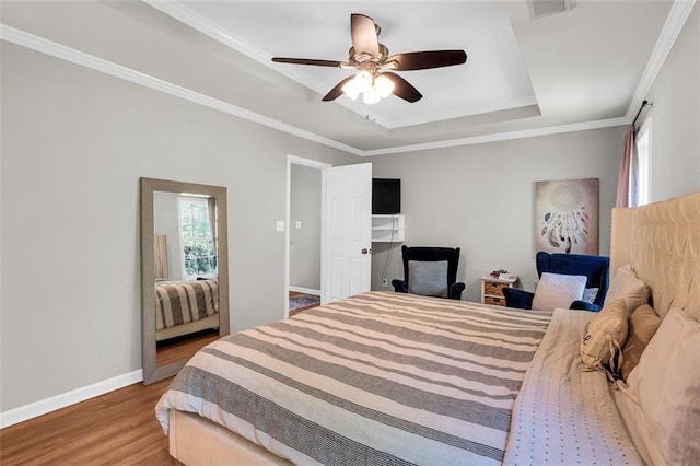 5990 Eagle Tiff Ln, Sugar Hill, GA 30518 - bedroom with wood finished floors, a tray ceiling, crown molding, and a ceiling fan