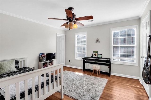 5990 Eagle Tiff Ln, Sugar Hill, GA 30518 - bedroom with ornamental molding, wood finished floors, and ceiling fan