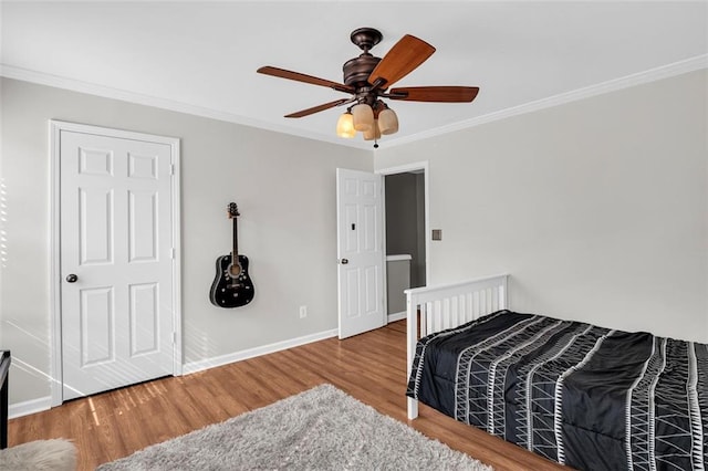 5990 Eagle Tiff Ln, Sugar Hill, GA 30518 - bedroom with wood finished floors, crown molding, and ceiling fan