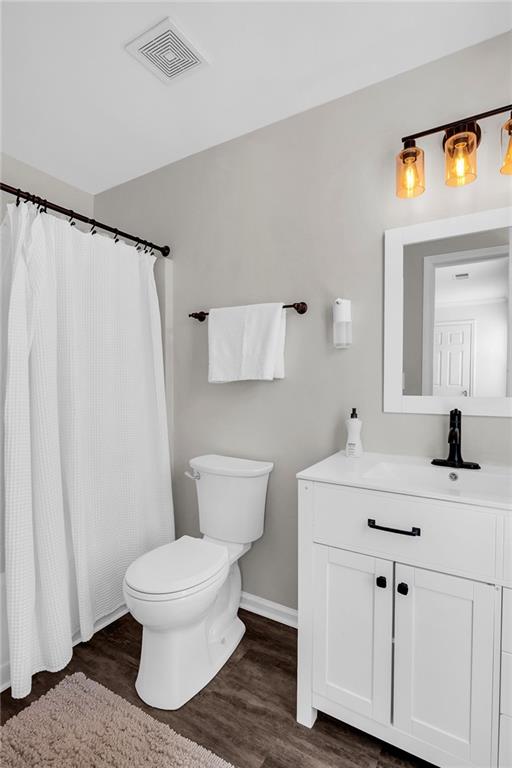 5990 Eagle Tiff Ln, Sugar Hill, GA 30518 - bathroom with vanity, wood finished floors, and a shower with curtain