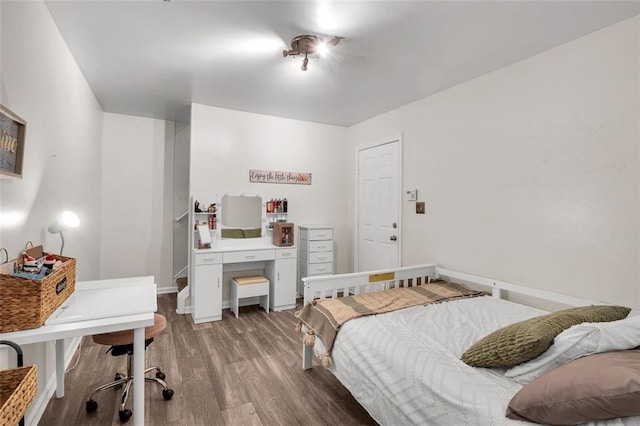 5990 Eagle Tiff Ln, Sugar Hill, GA 30518 - bedroom featuring wood finished floors and a desk