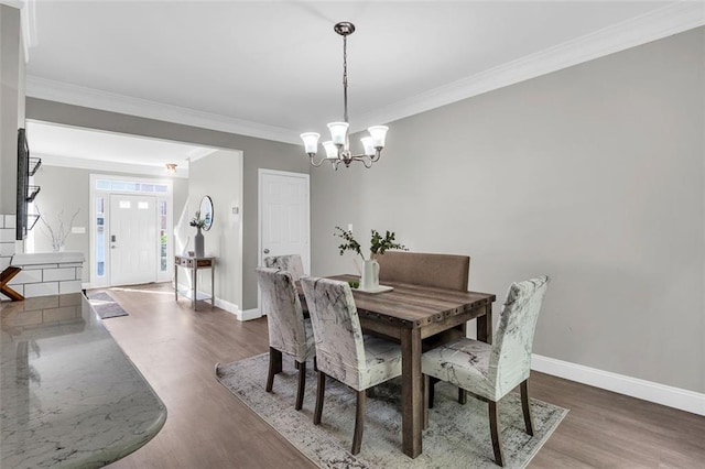 5990 Eagle Tiff Ln, Sugar Hill, GA 30518 - dining area featuring crown molding, wood finished floors, and a chandelier