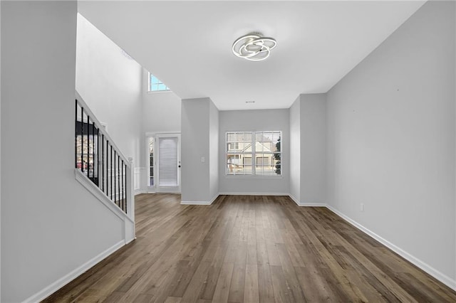 entrance foyer with a healthy amount of sunlight and dark hardwood / wood-style flooring