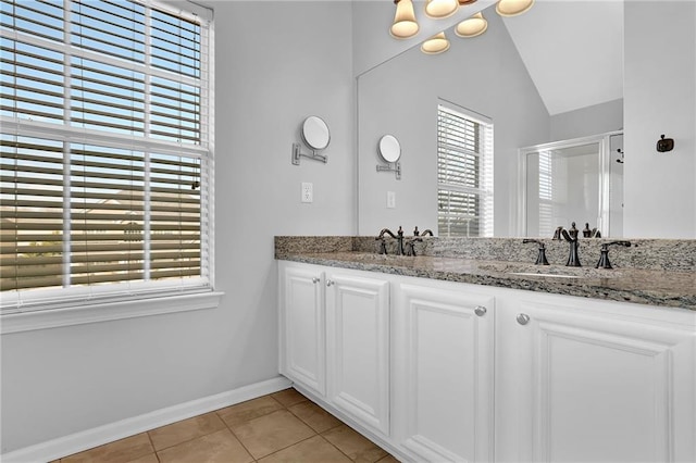 bathroom featuring lofted ceiling, tile patterned flooring, vanity, an enclosed shower, and an inviting chandelier