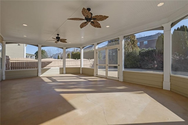 unfurnished sunroom featuring ceiling fan