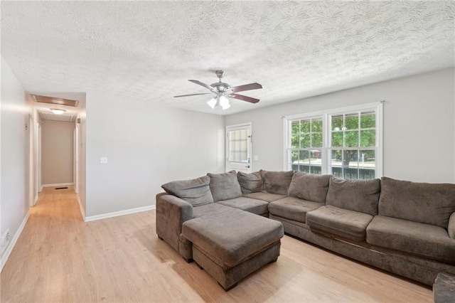 3388 Hamilton Mill Rd, Buford, GA 30519 - living area with light wood finished floors, a textured ceiling, ceiling fan, and baseboards