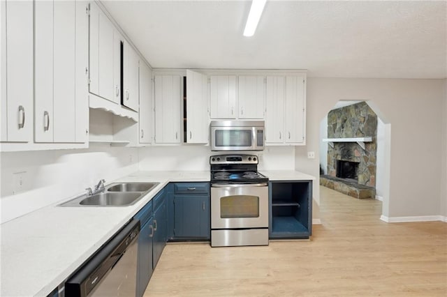 3388 Hamilton Mill Rd, Buford, GA 30519 - kitchen featuring appliances with stainless steel finishes, open shelves, a sink, and light wood-style flooring