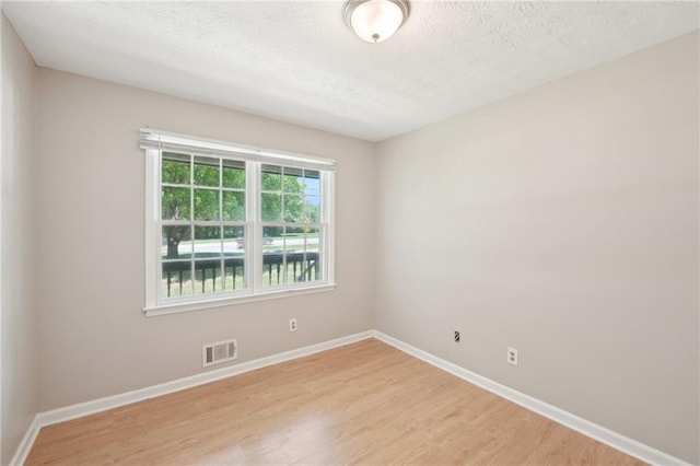 3388 Hamilton Mill Rd, Buford, GA 30519 - spare room featuring light wood finished floors, baseboards, and a textured ceiling