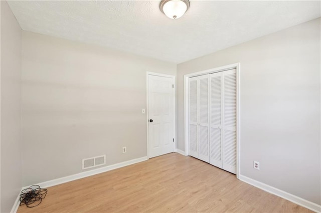 3388 Hamilton Mill Rd, Buford, GA 30519 - unfurnished bedroom featuring light wood-type flooring, baseboards, and a closet