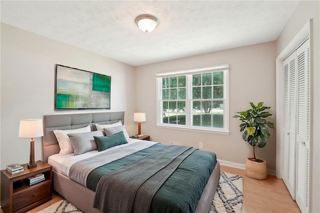 3388 Hamilton Mill Rd, Buford, GA 30519 - bedroom featuring light wood-type flooring, a closet, and baseboards