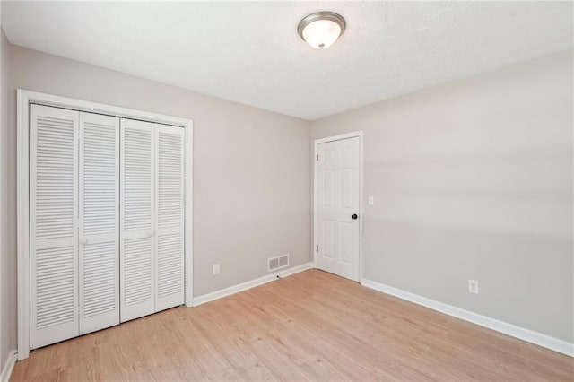 3388 Hamilton Mill Rd, Buford, GA 30519 - unfurnished bedroom with light wood-style floors, baseboards, and a closet