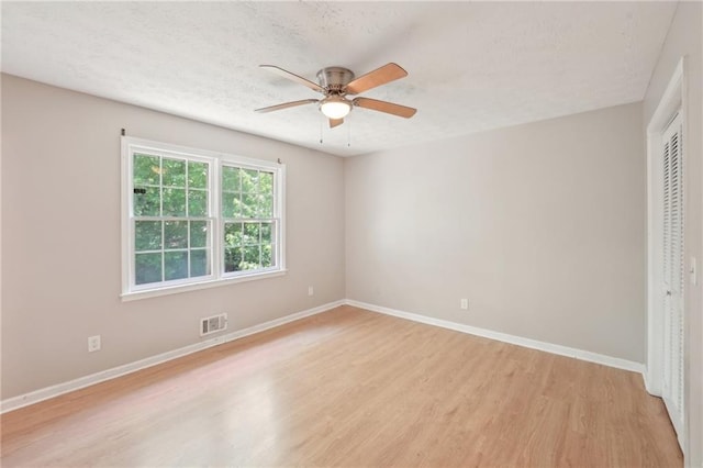 3388 Hamilton Mill Rd, Buford, GA 30519 - unfurnished bedroom with a closet, light wood-style flooring, baseboards, a textured ceiling, and ceiling fan