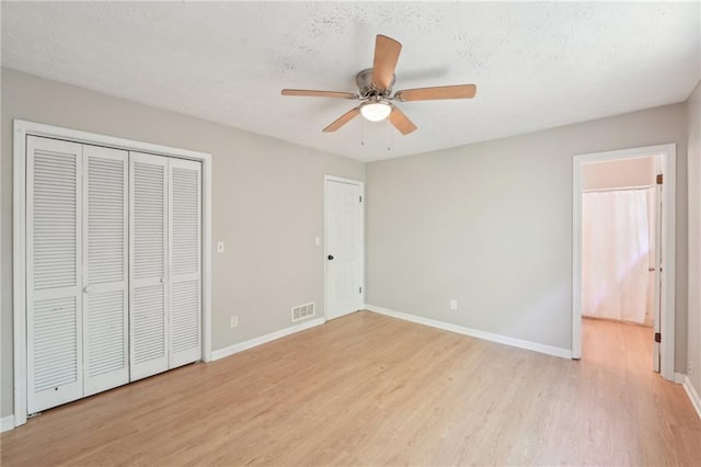 3388 Hamilton Mill Rd, Buford, GA 30519 - unfurnished bedroom featuring light wood-type flooring, baseboards, a textured ceiling, and ceiling fan