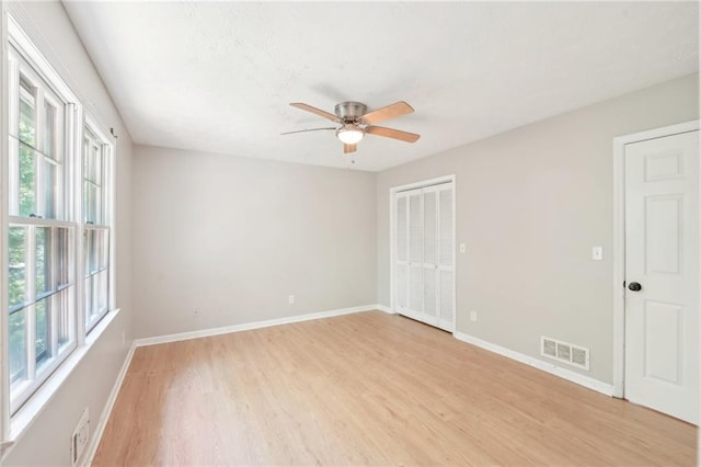 3388 Hamilton Mill Rd, Buford, GA 30519 - unfurnished bedroom featuring multiple windows, light wood finished floors, and baseboards