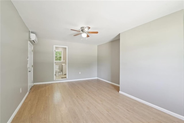 3388 Hamilton Mill Rd, Buford, GA 30519 - spare room featuring a ceiling fan, an AC wall unit, baseboards, and light wood finished floors