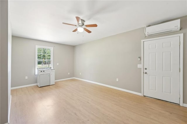 3388 Hamilton Mill Rd, Buford, GA 30519 - spare room with a wall mounted air conditioner, a ceiling fan, light wood-type flooring, and baseboards