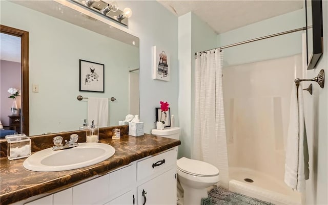 bathroom featuring vanity, toilet, and a shower with shower curtain