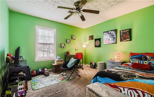 carpeted bedroom with a textured ceiling and ceiling fan