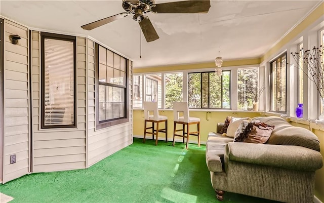 sunroom / solarium featuring ceiling fan