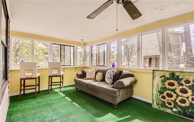 sunroom with plenty of natural light and ceiling fan