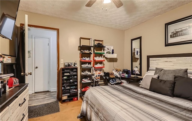 carpeted bedroom with a textured ceiling and ceiling fan