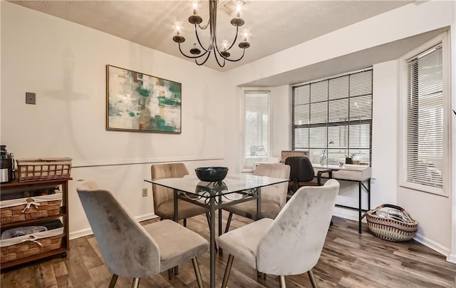 dining area featuring an inviting chandelier and hardwood / wood-style floors