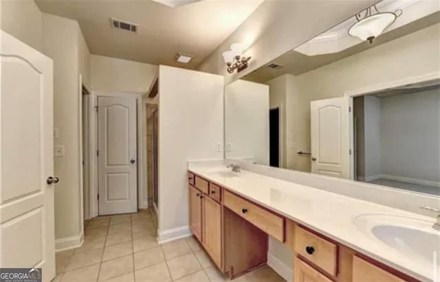 bathroom with double vanity, tile patterned flooring, a sink, and visible vents