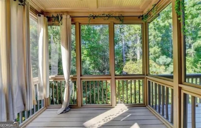 unfurnished sunroom featuring wooden ceiling