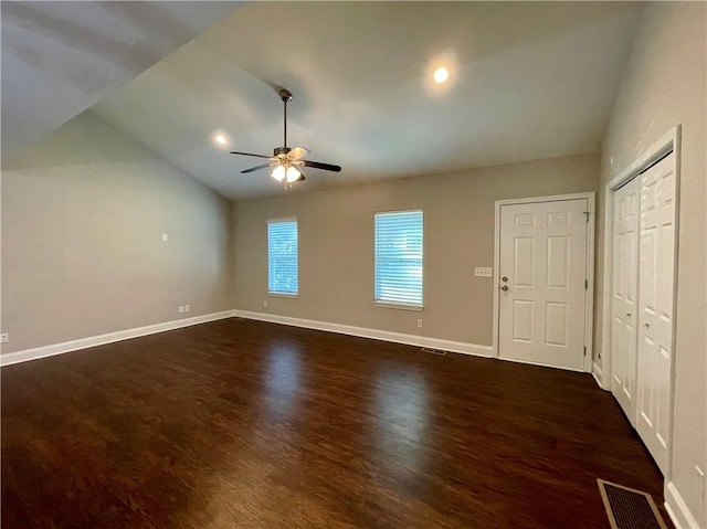 interior space featuring ceiling fan, vaulted ceiling, and dark hardwood / wood-style floors