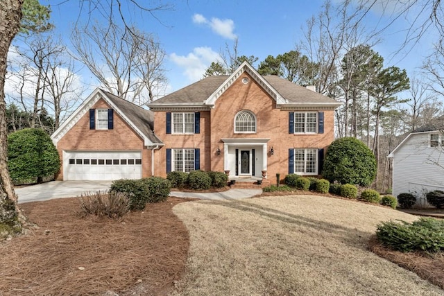 view of front of house featuring brick siding, driveway, a shingled roof, and a garage