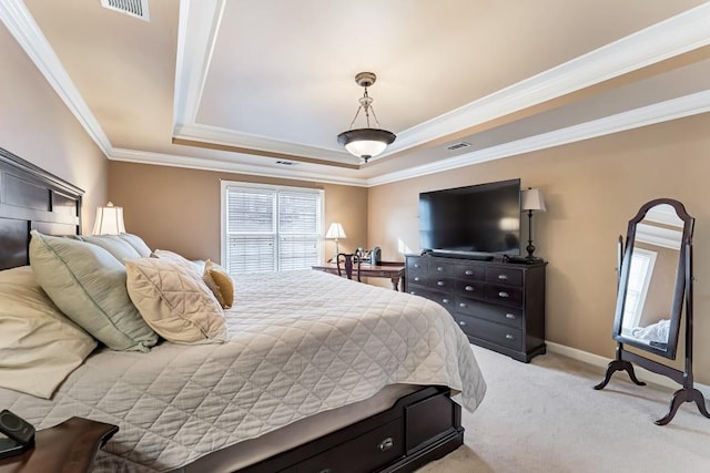 bedroom featuring visible vents, light carpet, a tray ceiling, crown molding, and baseboards