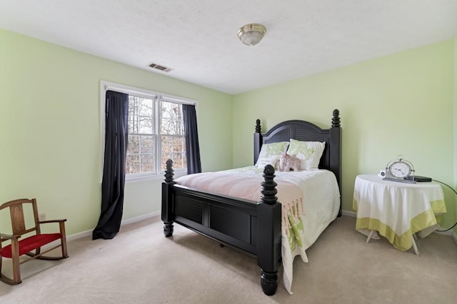 carpeted bedroom with baseboards and visible vents