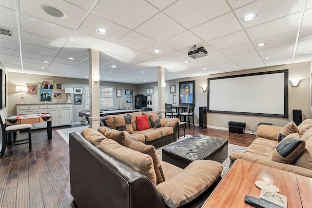 home theater with visible vents, ornate columns, baseboards, recessed lighting, and dark wood-style flooring