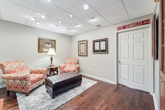 sitting room featuring visible vents, dark wood-style floors, recessed lighting, a paneled ceiling, and baseboards