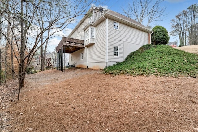 view of property exterior featuring a wooden deck and central AC unit