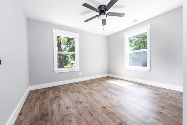 8420 Sheridan Dr, Jonesboro, GA 30236 - spare room with plenty of natural light, wood finished floors, a ceiling fan, and baseboards