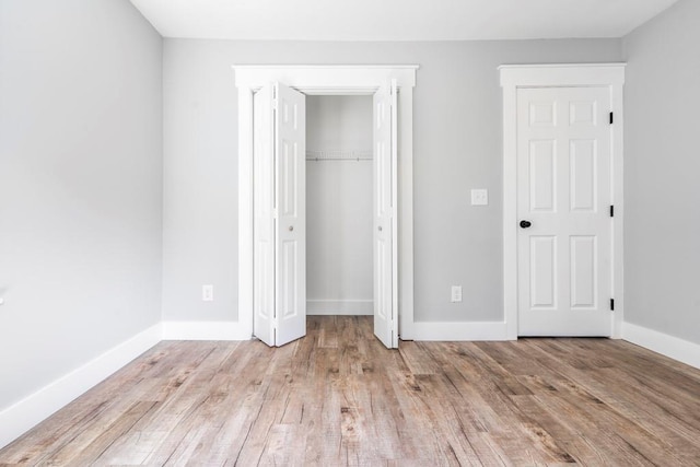 8420 Sheridan Dr, Jonesboro, GA 30236 - unfurnished bedroom featuring light wood-style floors, baseboards, and a closet