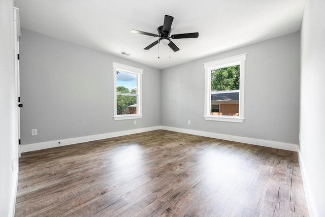 8420 Sheridan Dr, Jonesboro, GA 30236 - spare room with healthy amount of natural light, wood finished floors, and a ceiling fan
