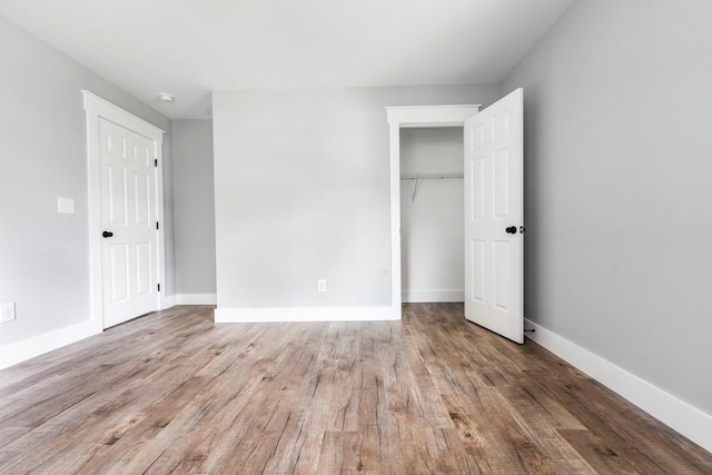8420 Sheridan Dr, Jonesboro, GA 30236 - unfurnished bedroom featuring a closet, wood finished floors, and baseboards