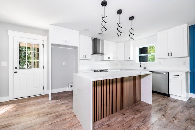 8420 Sheridan Dr, Jonesboro, GA 30236 - kitchen featuring stainless steel appliances, wall chimney range hood, healthy amount of natural light, and white cabinetry