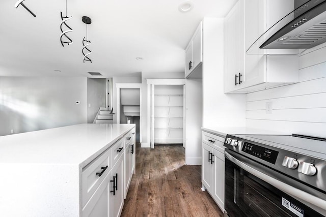 8420 Sheridan Dr, Jonesboro, GA 30236 - kitchen with stainless steel range with electric cooktop, ventilation hood, light countertops, dark wood-type flooring, and recessed lighting