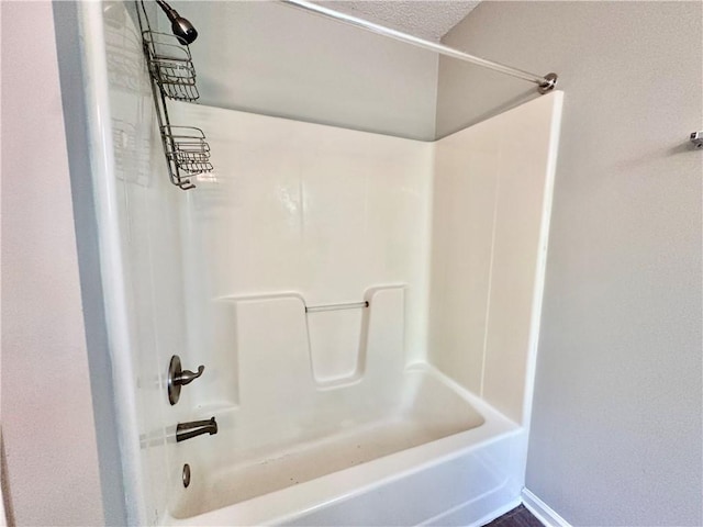 full bath featuring baseboards and shower / bath combination