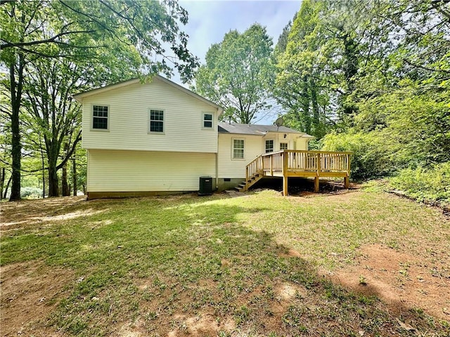 rear view of property featuring a deck, central AC unit, a yard, and crawl space